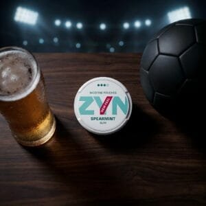 Nicotine pouch tin next to a soccer ball and a cold glass of beer, prepping for the 2026 World Cup.